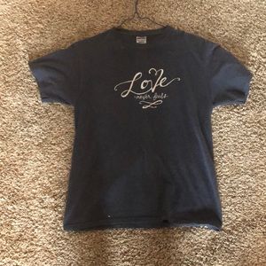 Navy blue “love never fails” graphic T-shirt